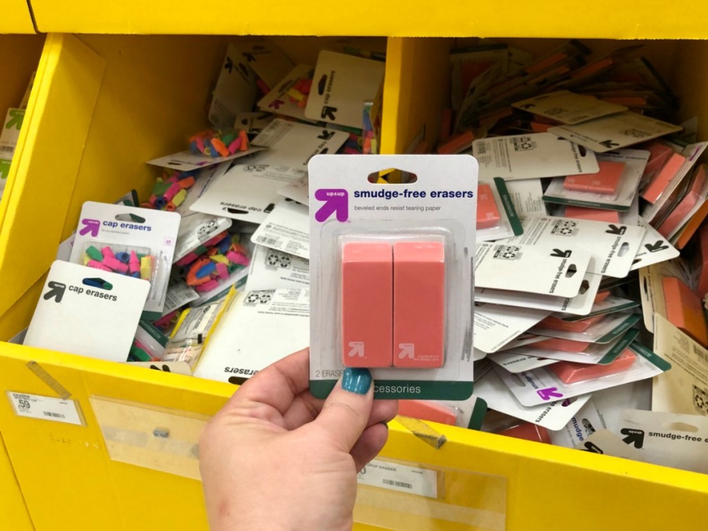 woman hand holding pack of up and up erasers