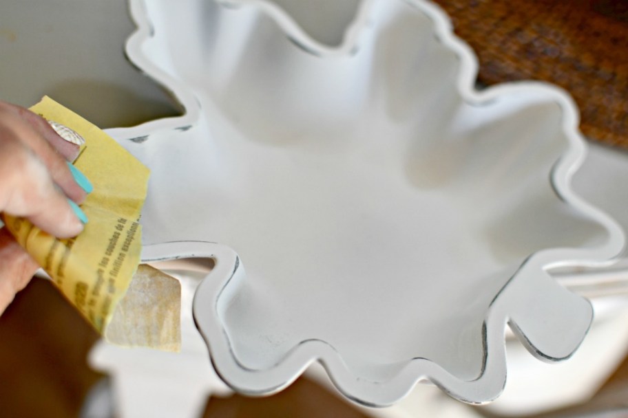 sanding the edges of painted dollar tree dish