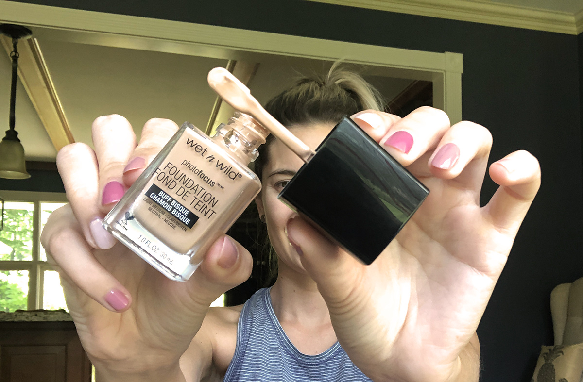 emily holding up wet n wild foundation