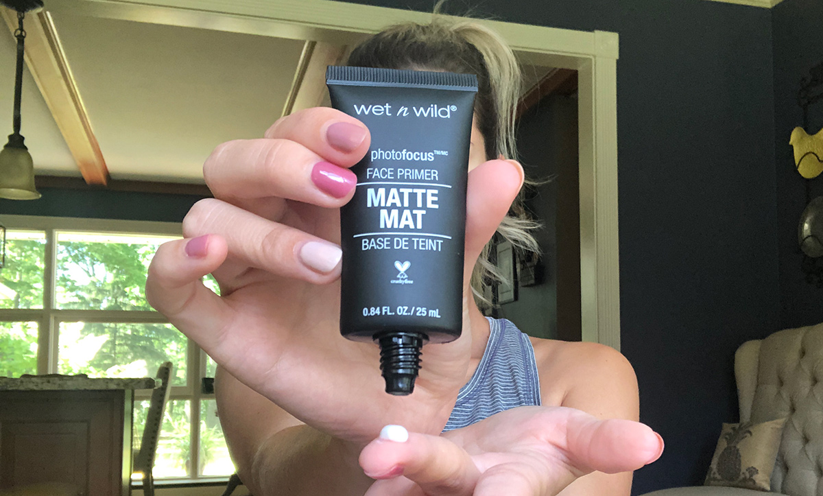 emily holding up wet n wild matte primer