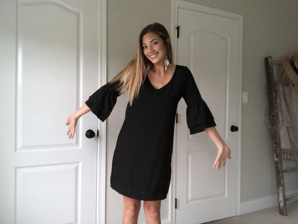 woman wearing black bell-sleeve dress 