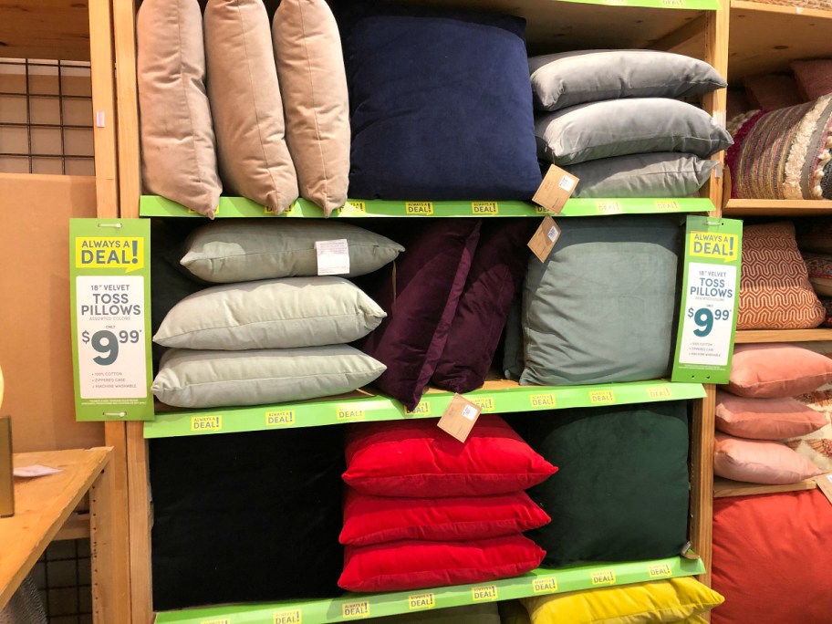 stacks of velvet pillows on shelf