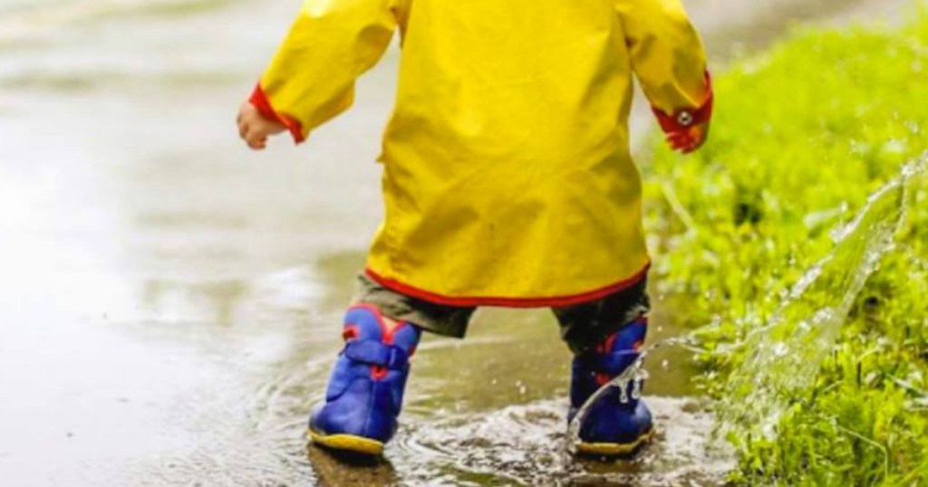 boy splashing in puddles with Bogs Boots