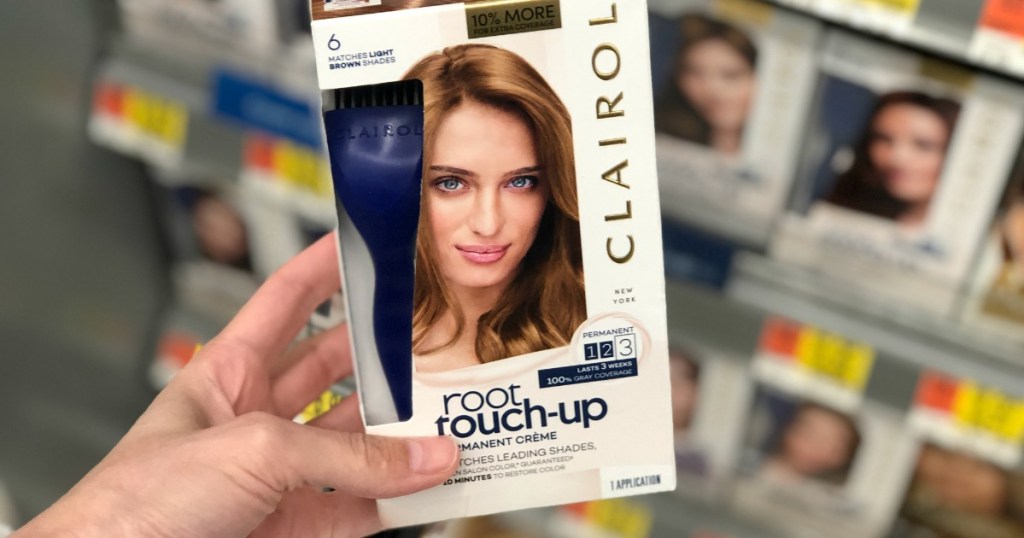 Clairol Root Touch-Up being held by a woman's hand