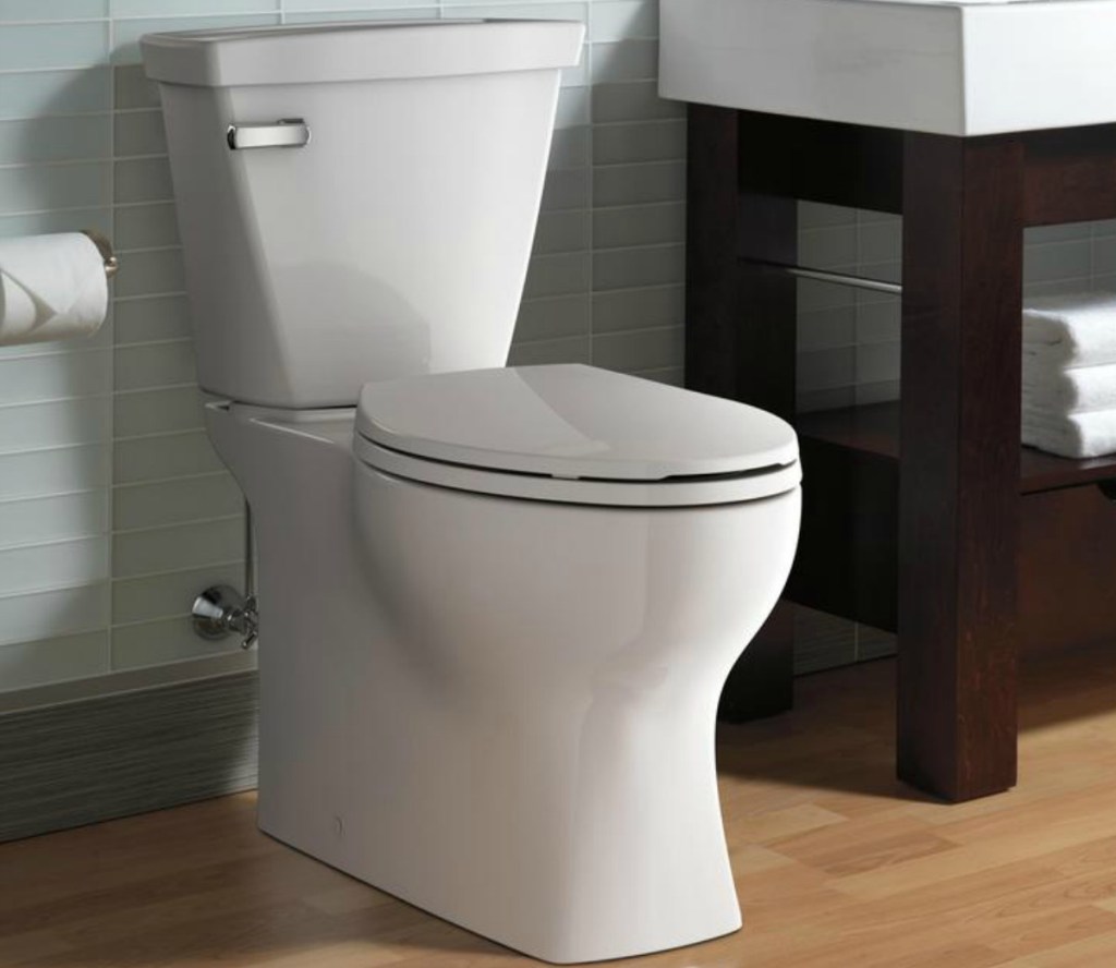 A white porcelain toilet in bathroom setting 