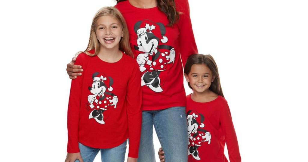 woman and girls wearing matching Disney holiday tees