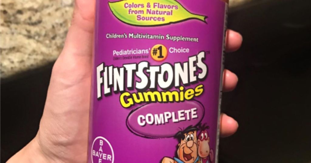 hand holding up bottle of flintstones vitamins