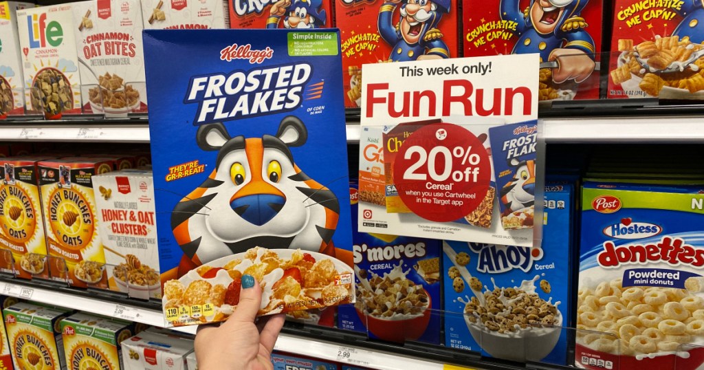 hand holding up box of frosted flakes cereal at target