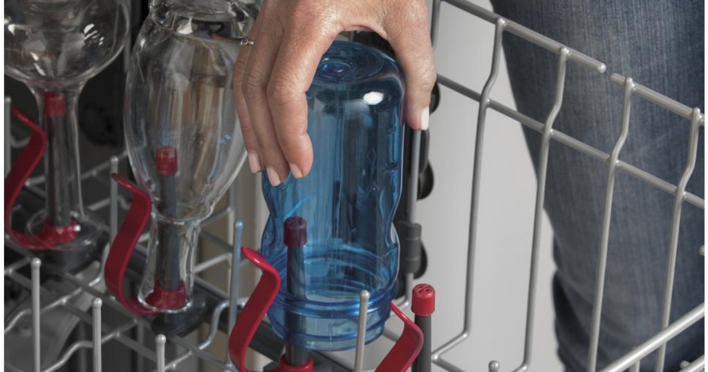 woman putting cup in ge dishwasher