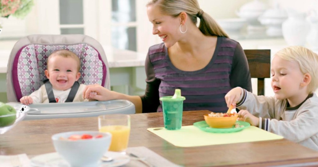 mother and two children sitting and laughing at table