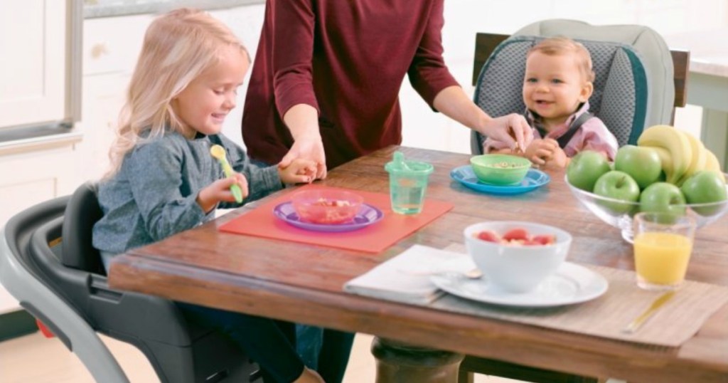 two children in high chairs seated at a table