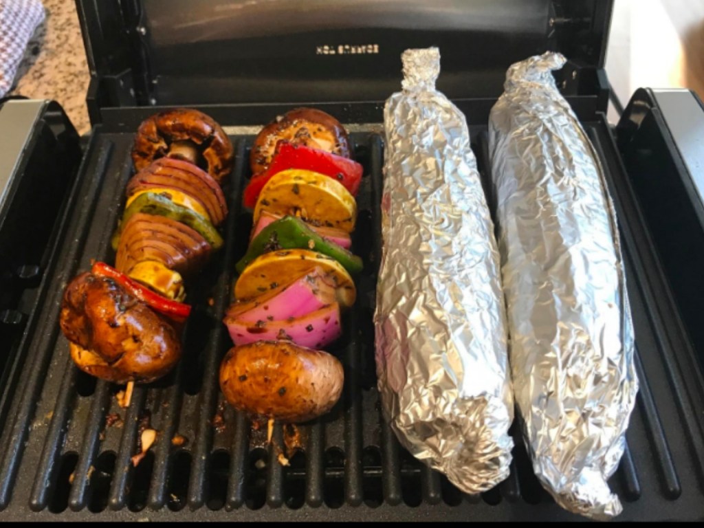 corn on the cobb and veggies on a grill