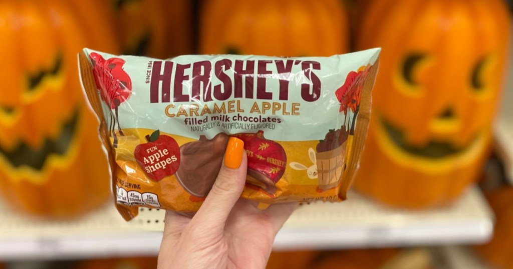 Woman holding bag of Hershey's Caramel Apple Filled Milk Chocolates