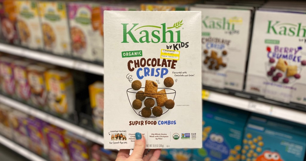 hand holding up box of kids kashi cereal at target