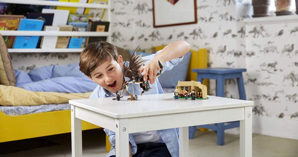 kid playing with lego harry potter set