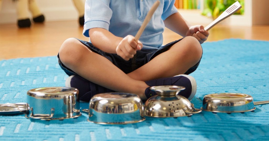 kid playing with melissa and doug pots and pans set