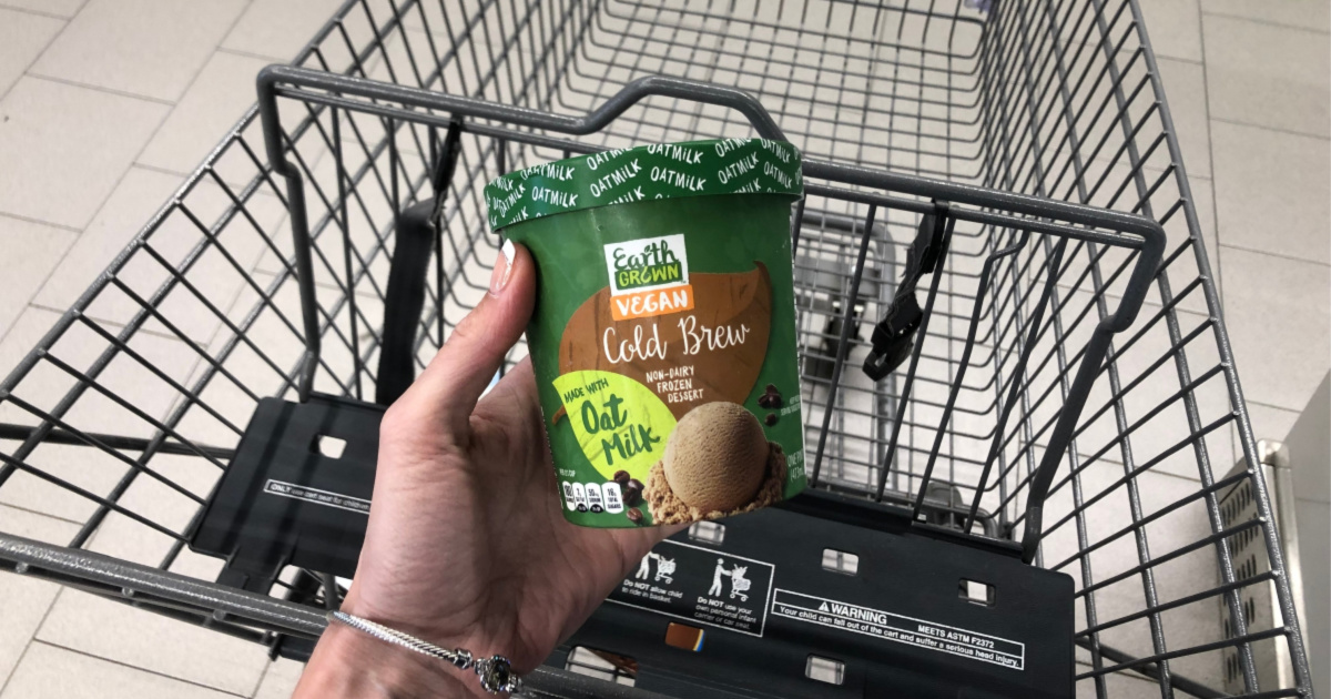 woman holding up pint of oat based cold brew ice cream