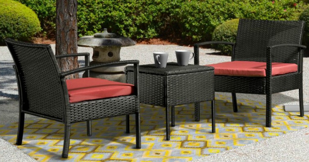 wicker patio seating set outside under an umbrella