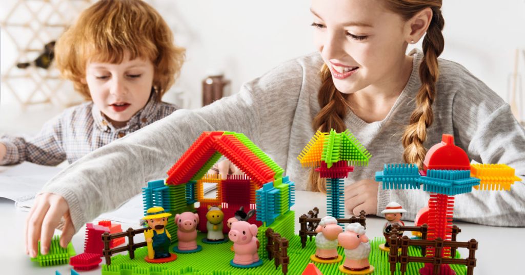 two kids playing with picasso tiles set