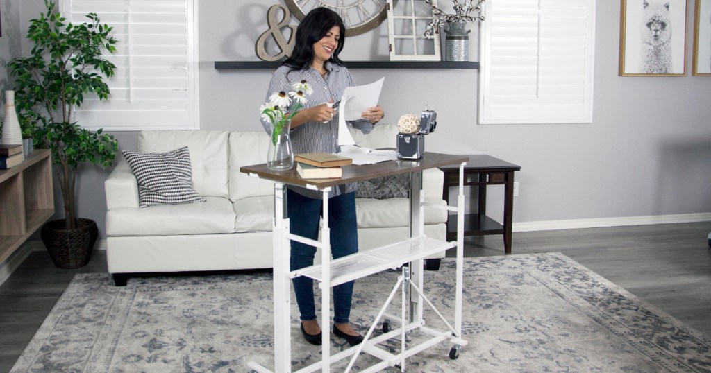 woman using white sit stand desk