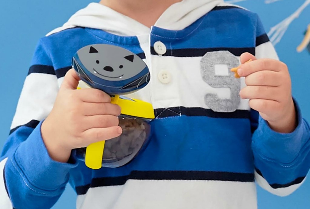 Skip Hop bat snack bowl in hand of boy eating goldfish crackers