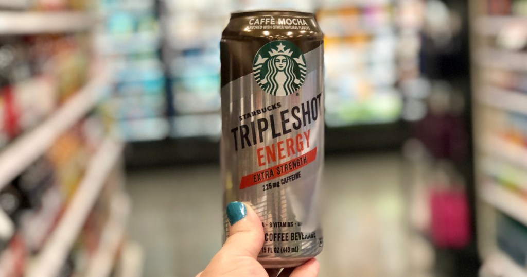 hand holding up starbucks tripleshot drink at target