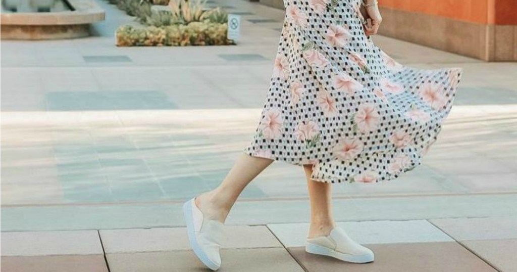 woman in dress wearing leather slip-on shoes