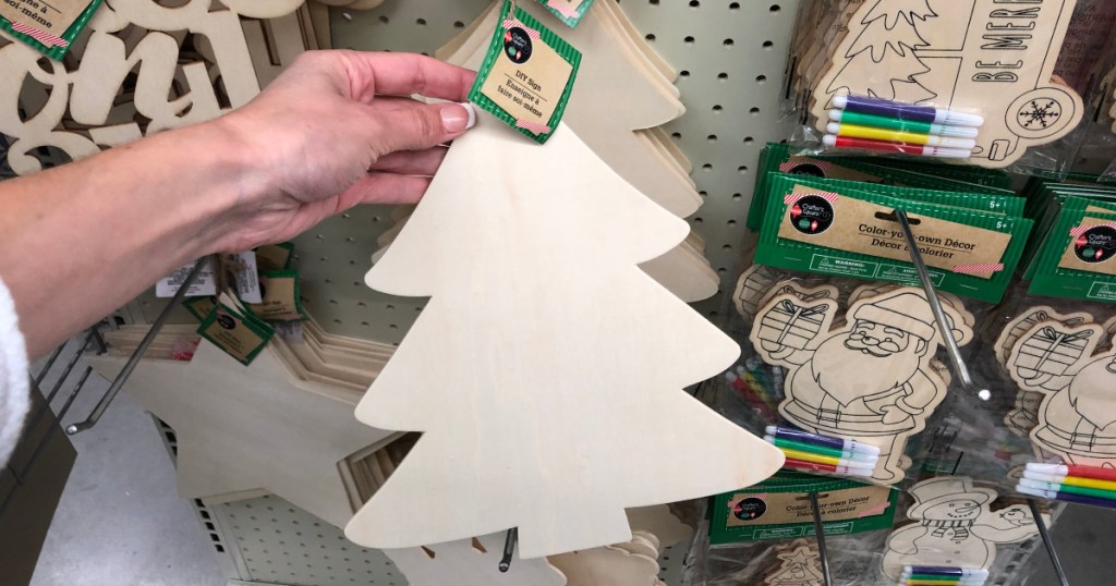 hand holding up wooden christmas tree