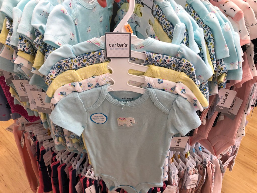 carter's bodysuit set hanging on store rack