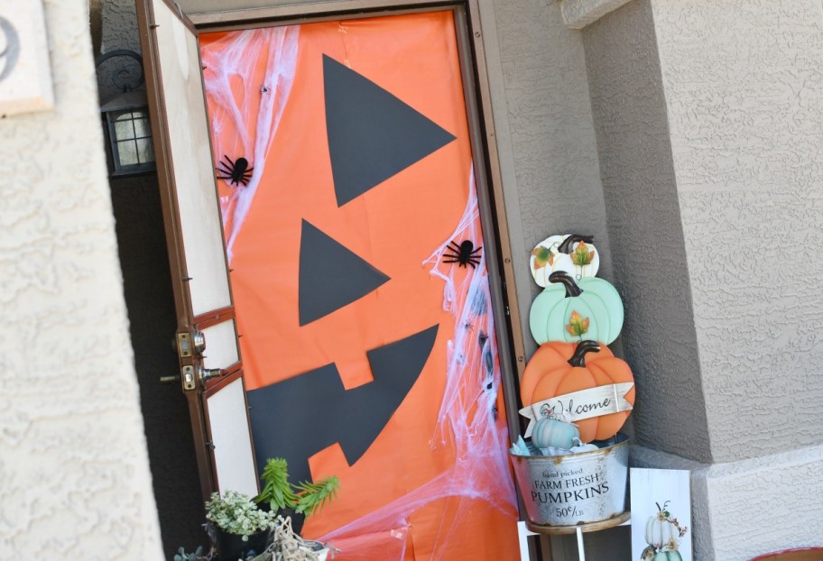 front door with jack-o-lantern wrapping paper on it