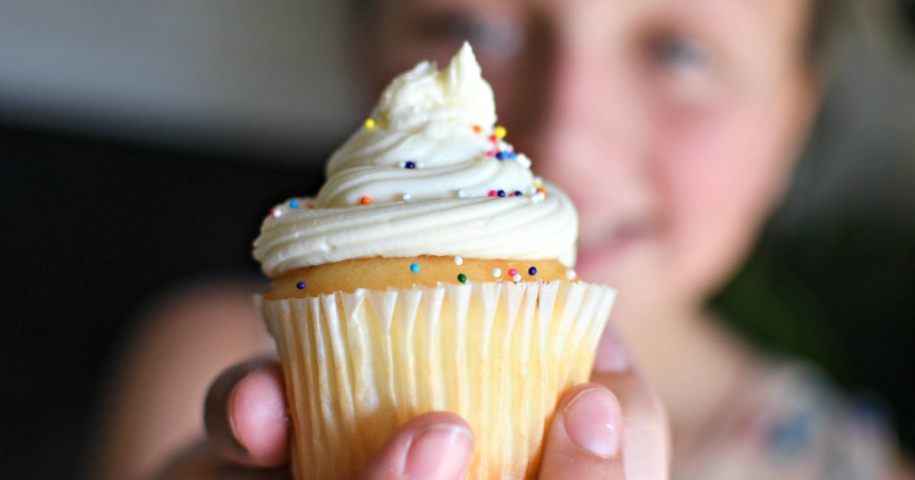 girl holding a cupcake