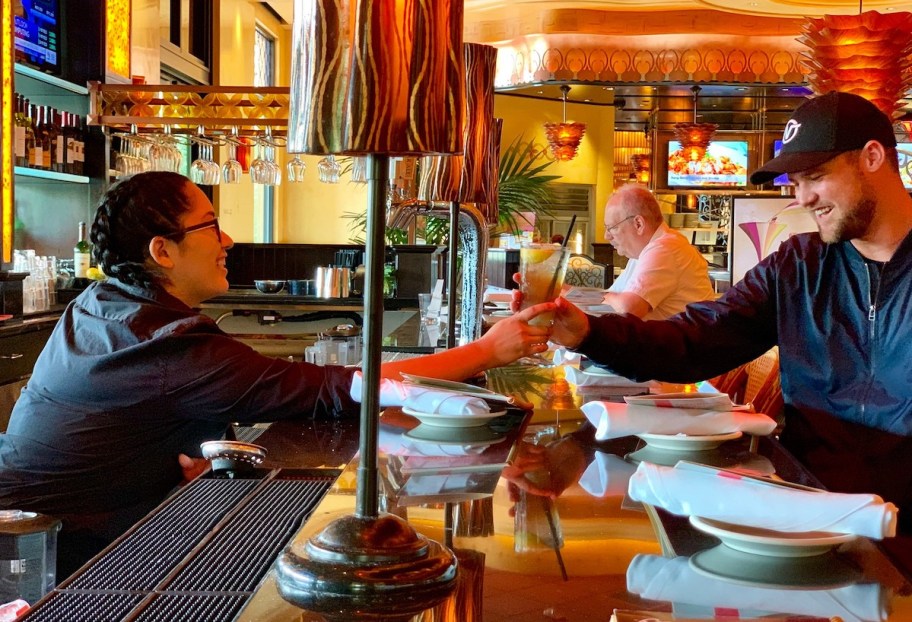 stetson and bartender holding drink in cheesecake factory bar 