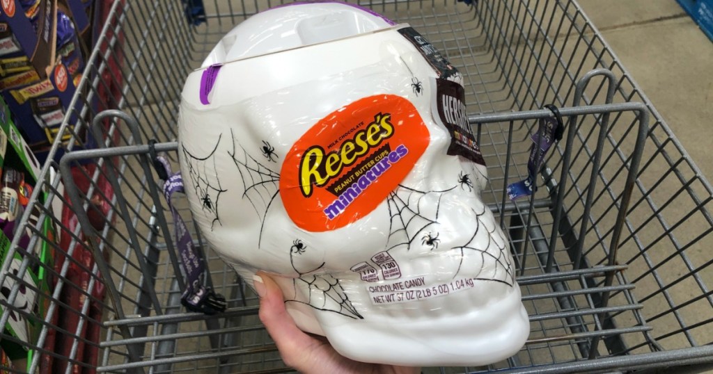 hand holding skull shaped candy bowl in store