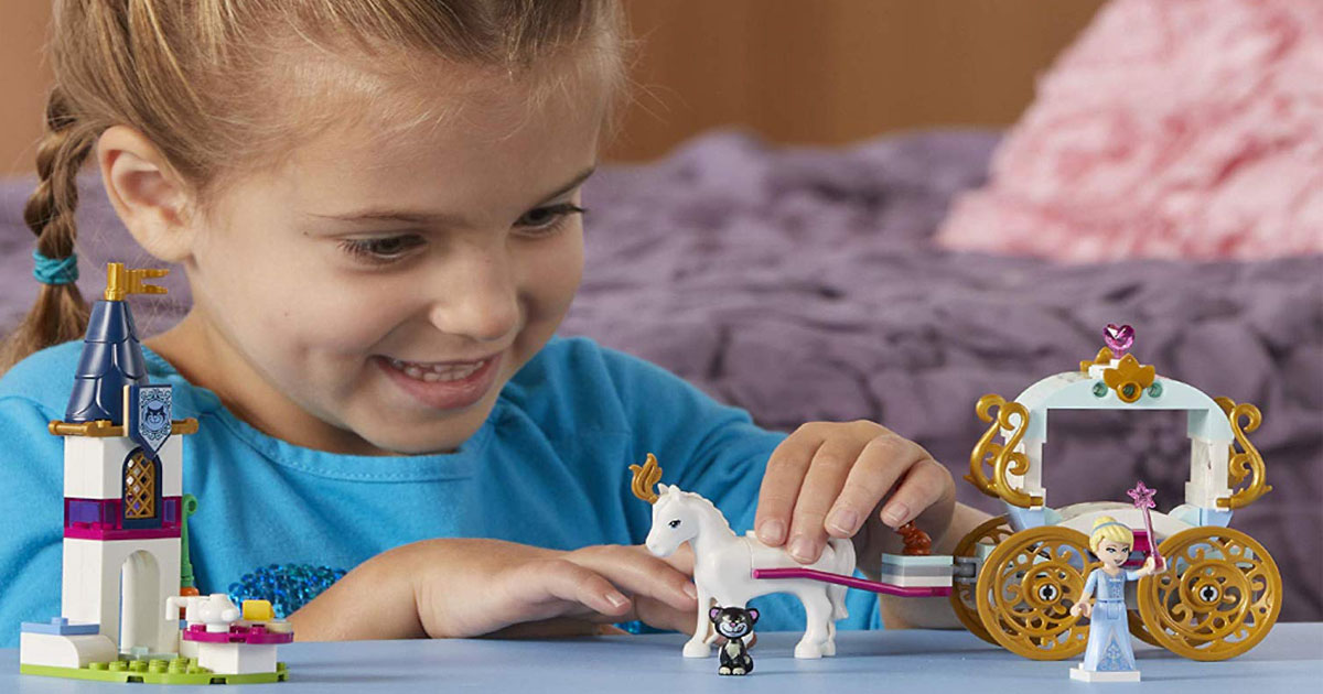 Little girl playing with LEGO Disney Princess Carriage set