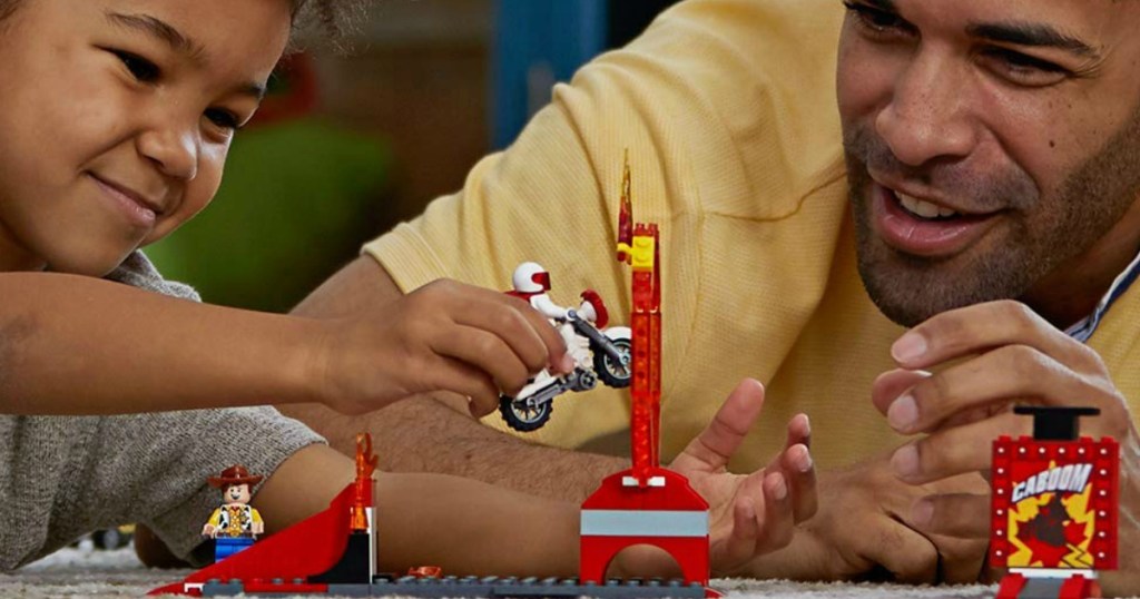 little boy and dad playing with lego set