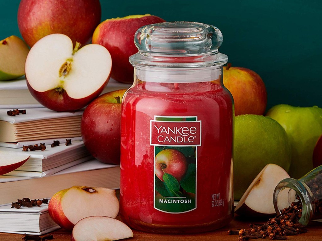 yankee candle macintosh with apples and books behind candle