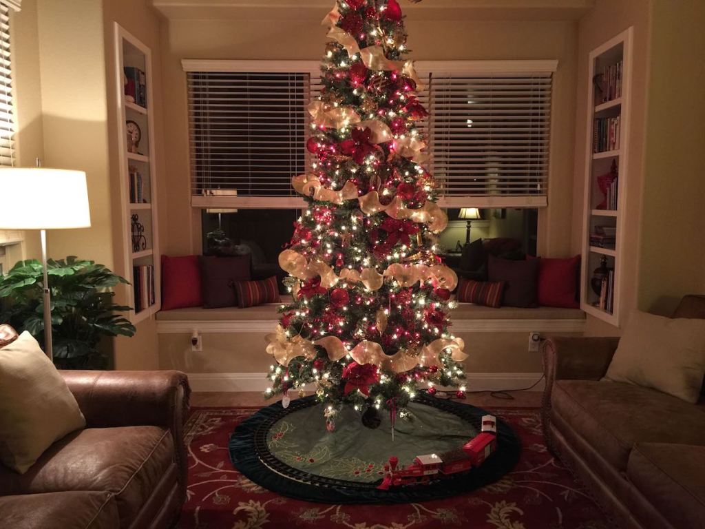 christmas tree in living room with train 