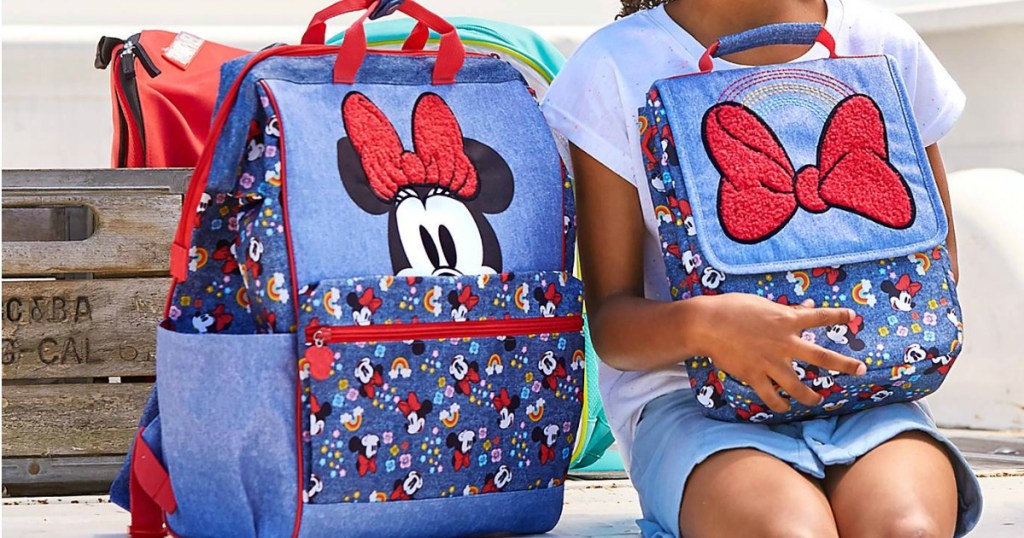 little girl with lunch bag and bookbag