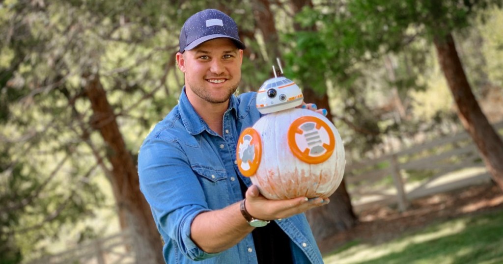 man holding BB-8 decorated pumpkin