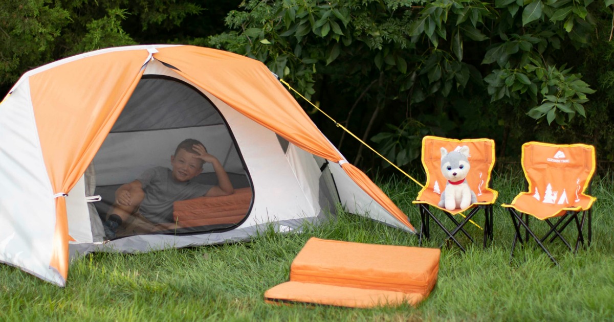 boy relaxing in tent next to kids chairs