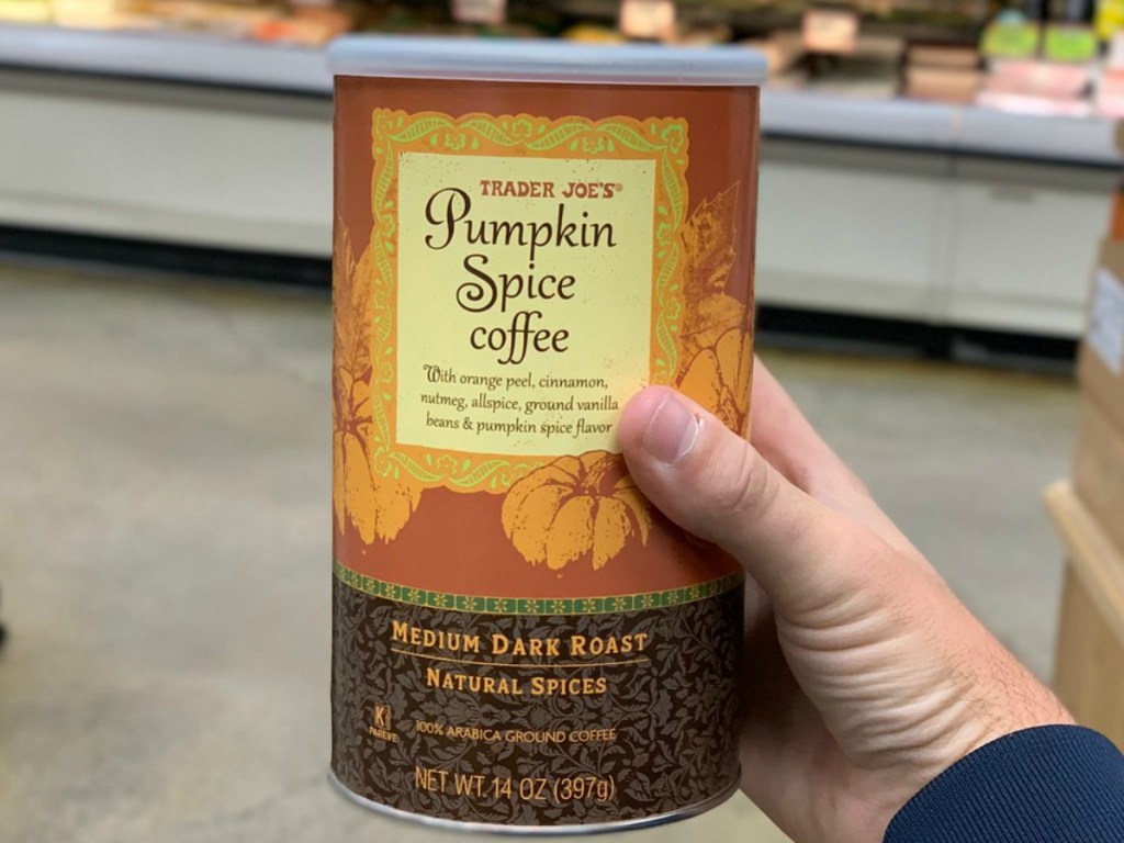 hand holding can of coffee in store