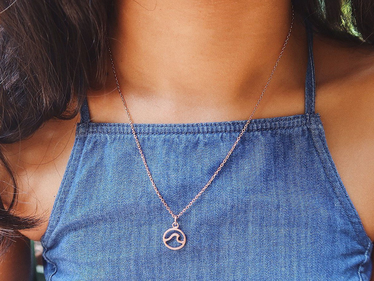 girl wearing a wave necklace