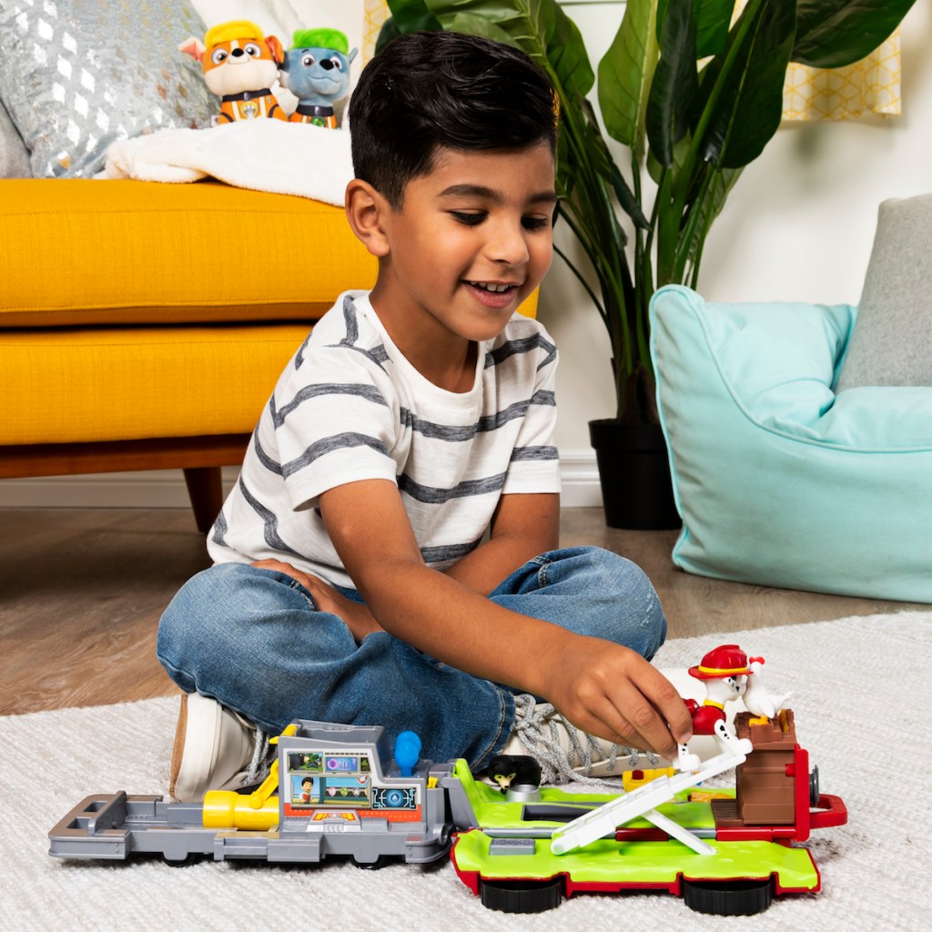 boy playing with Paw Patrol Rescue Vehicle