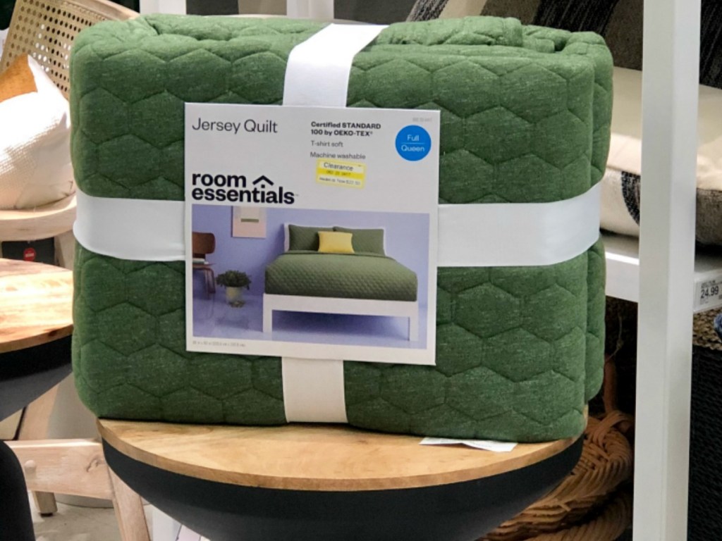 green quilt on table in store