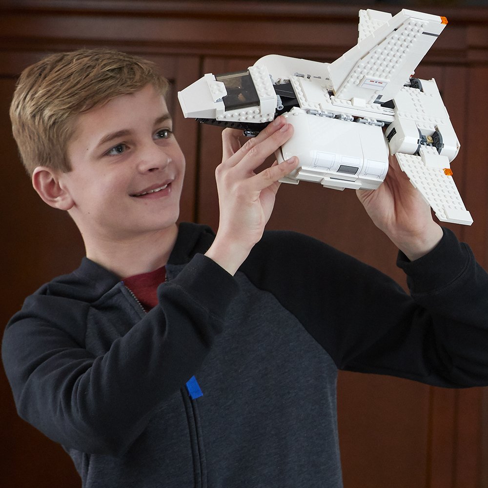 boy playing with LEGO star wars landing craft 