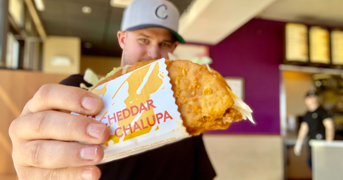 man holding Taco Bell cheddar chalupa