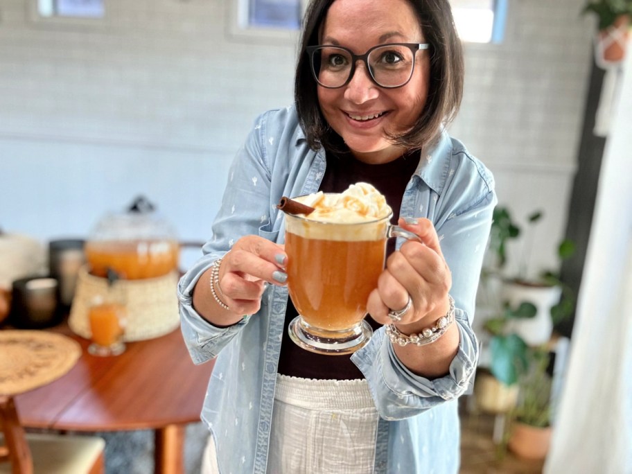 woman holding a mug of hot apple cider