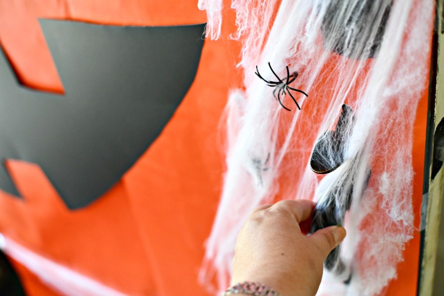 wrapping a door as a jack-o-lantern, one of our favorite Halloween door ideas