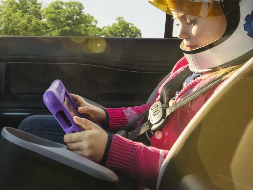 Kid in a carseat using a Amazon Kids Fire Tablet QVC