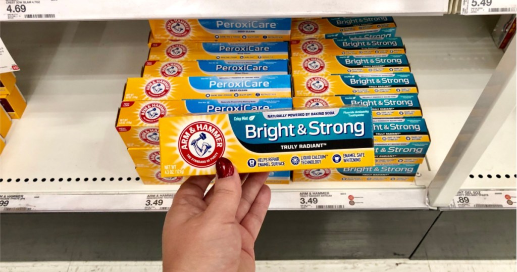 hand holding up box of arm & hammer toothpaste at target